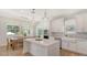 Bright kitchen with white cabinetry, quartz countertops, stainless appliances, and an adjacent dining area at 6136 Hollywood Blvd, Sarasota, FL 34231