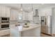 Modern kitchen featuring white cabinetry, stainless steel appliances, a center island with quartz countertops, and stylish lighting at 6136 Hollywood Blvd, Sarasota, FL 34231