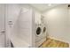 Bright laundry room with white cabinets, modern washer and dryer at 6136 Hollywood Blvd, Sarasota, FL 34231