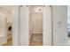 Laundry room with sliding doors showcasing modern washer, dryer, and cabinets at 6136 Hollywood Blvd, Sarasota, FL 34231