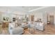 Spacious living area open to kitchen with tile floors, neutral color palette and comfortable seating at 6136 Hollywood Blvd, Sarasota, FL 34231