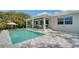 A stunning backyard featuring a refreshing pool, a covered patio, and beautiful outdoor tile at 6136 Hollywood Blvd, Sarasota, FL 34231