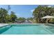 Backyard with inviting pool overlooking a serene canal and lush greenery at 6136 Hollywood Blvd, Sarasota, FL 34231