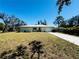 Charming single-story home featuring a well-maintained lawn and concrete driveway at 616 Shore Rd, Nokomis, FL 34275