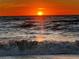 A radiant sunset illuminates the sky above the ocean waves at 616 Shore Rd, Nokomis, FL 34275