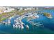 Aerial view of marina with multiple boats docked in the water and buildings in the background at 650 Golden Gate Pt # 602, Sarasota, FL 34236