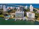 Breathtaking aerial view of waterfront condo, marina, and vibrant city skyline at 650 Golden Gate Pt # 602, Sarasota, FL 34236