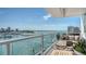 Inviting balcony with comfortable seating, plants, and serene marina views at 650 Golden Gate Pt # 602, Sarasota, FL 34236