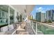 Comfortable balcony seating area with views of the city and waterfront at 650 Golden Gate Pt # 602, Sarasota, FL 34236