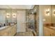 Modern bathroom featuring a glass enclosed tile shower, double sink with granite countertop, and contemporary fixtures at 650 Golden Gate Pt # 602, Sarasota, FL 34236