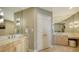 Elegant bathroom featuring dual vanities, large mirrors, and stylish lighting fixtures at 650 Golden Gate Pt # 602, Sarasota, FL 34236