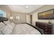 Comfortable bedroom featuring a ceiling fan, ensuite bath, and neutral color scheme at 650 Golden Gate Pt # 602, Sarasota, FL 34236