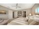 Bright bedroom with an ensuite bath, ceiling fan, and neutral color palette at 650 Golden Gate Pt # 602, Sarasota, FL 34236