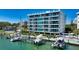 Beautiful condominium with multiple boat docks and a waterfront swimming pool and manicured shrubbery at 650 Golden Gate Pt # 602, Sarasota, FL 34236