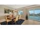 Bright dining area with large windows offering scenic waterfront views, stylish decor, and comfortable seating at 650 Golden Gate Pt # 602, Sarasota, FL 34236