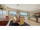 Dining room features large windows with city views, a modern light fixture, and comfortable seating for six at 650 Golden Gate Pt # 602, Sarasota, FL 34236
