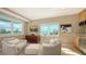 Bright living room with beautiful views, cozy seating, and kitchenette at 650 Golden Gate Pt # 602, Sarasota, FL 34236