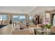 Large open living room featuring expansive windows with city views, neutral furniture, and tile floors at 650 Golden Gate Pt # 602, Sarasota, FL 34236