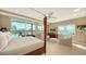 Luxurious main bedroom with beautiful waterfront views, sitting area, a king-size bed and stylish decor at 650 Golden Gate Pt # 602, Sarasota, FL 34236