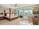 The luxurious main bedroom features incredible views, stylish furnishings, and a comfortable sitting area at 650 Golden Gate Pt # 602, Sarasota, FL 34236