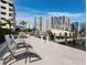 Picturesque view of waterfront marina with boat docks, lounge chairs and skyline at 650 Golden Gate Pt # 602, Sarasota, FL 34236