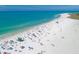 Wide beach coastline with light blue ocean and beachgoers at 6512 Midnight Pass Rd # 504, Sarasota, FL 34242
