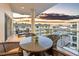 Relaxing balcony featuring a table and chairs with gorgeous sunset views overlooking the city at 6512 Midnight Pass Rd # 504, Sarasota, FL 34242