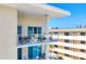 The condo offers a spacious balcony with glass railings and seating that captures the ocean view at 6512 Midnight Pass Rd # 504, Sarasota, FL 34242