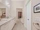 Bathroom with double sinks, white cabinetry, and a large walk-in shower at 6512 Midnight Pass Rd # 504, Sarasota, FL 34242
