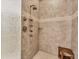 Modern tiled shower with multiple shower heads and a built-in bench at 6512 Midnight Pass Rd # 504, Sarasota, FL 34242
