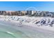 Beautiful coastline view of the condo residences with beach umbrellas and people relaxing by the water at 6512 Midnight Pass Rd # 504, Sarasota, FL 34242