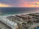 A serene view of condominiums located close to the beach with beautiful sky at 6512 Midnight Pass Rd # 504, Sarasota, FL 34242
