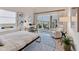 Bedroom with a large bed, desk, and a balcony overlooking the outdoors at 6512 Midnight Pass Rd # 504, Sarasota, FL 34242