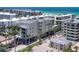 Exterior elevation of a modern condo building near the beach with palm trees at 6512 Midnight Pass Rd # 504, Sarasota, FL 34242