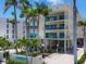 A beautiful condominium building with lush tropical landscaping and inviting facade at 6512 Midnight Pass Rd # 504, Sarasota, FL 34242