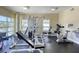 Community gym featuring weight machines, stationary bikes, and ample natural light at 6512 Midnight Pass Rd # 504, Sarasota, FL 34242