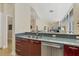 Modern kitchen area featuring stainless steel appliances, sleek cabinetry, and a light countertop at 6512 Midnight Pass Rd # 504, Sarasota, FL 34242