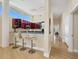 Stylish kitchen bar with seating and modern lighting fixtures overlooking a hallway at 6512 Midnight Pass Rd # 504, Sarasota, FL 34242