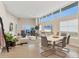 Spacious open-concept living room with modern furniture, large windows, and plenty of natural light at 6512 Midnight Pass Rd # 504, Sarasota, FL 34242