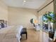 Serene primary bedroom with a private balcony and a comfortable seating area at 6512 Midnight Pass Rd # 504, Sarasota, FL 34242
