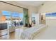 Bright primary bedroom with balcony access and a peek into the en-suite bathroom at 6512 Midnight Pass Rd # 504, Sarasota, FL 34242