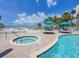 Relaxing pool area with a spa, lounge chairs, and views of the beach at 6512 Midnight Pass Rd # 504, Sarasota, FL 34242