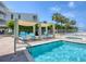 Exterior view of a relaxing pool area with lounge chairs and palm trees at 6512 Midnight Pass Rd # 504, Sarasota, FL 34242