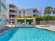 Beautiful pool area featuring a modern design, comfortable lounge chairs, and shaded areas at 6512 Midnight Pass Rd # 504, Sarasota, FL 34242