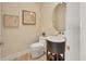 Chic powder room with a modern vanity, round mirror, and stylish wall art at 6512 Midnight Pass Rd # 504, Sarasota, FL 34242