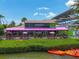 Bright waterfront restaurant featuring outdoor dining with vibrant pink awnings and lush tropical landscaping at 6512 Midnight Pass Rd # 504, Sarasota, FL 34242