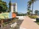 Welcome to Siesta Key Village sign with landscaping and a view of nearby buildings at 6512 Midnight Pass Rd # 504, Sarasota, FL 34242