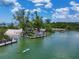 Scenic waterfront featuring docks, paddleboarders, and lush greenery at 6512 Midnight Pass Rd # 504, Sarasota, FL 34242