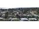 An aerial shot showcases a residential neighborhood with tree-lined streets and diverse home styles near the water at 6520 Clemson St, Bradenton, FL 34207