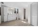Bright bathroom featuring a white vanity with storage, a toilet, and a walk-in shower with a tile surround at 6520 Clemson St, Bradenton, FL 34207
